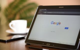 Tablet on a desk showing Google search engine in web browser window